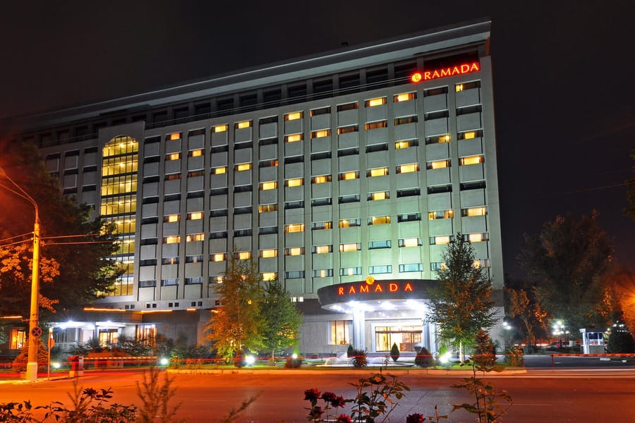 Ramada Tashkent lit at night, seen from the street