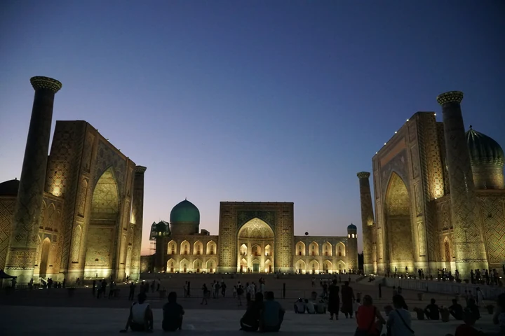 Registan Square in Samarkand illuminated at dusk